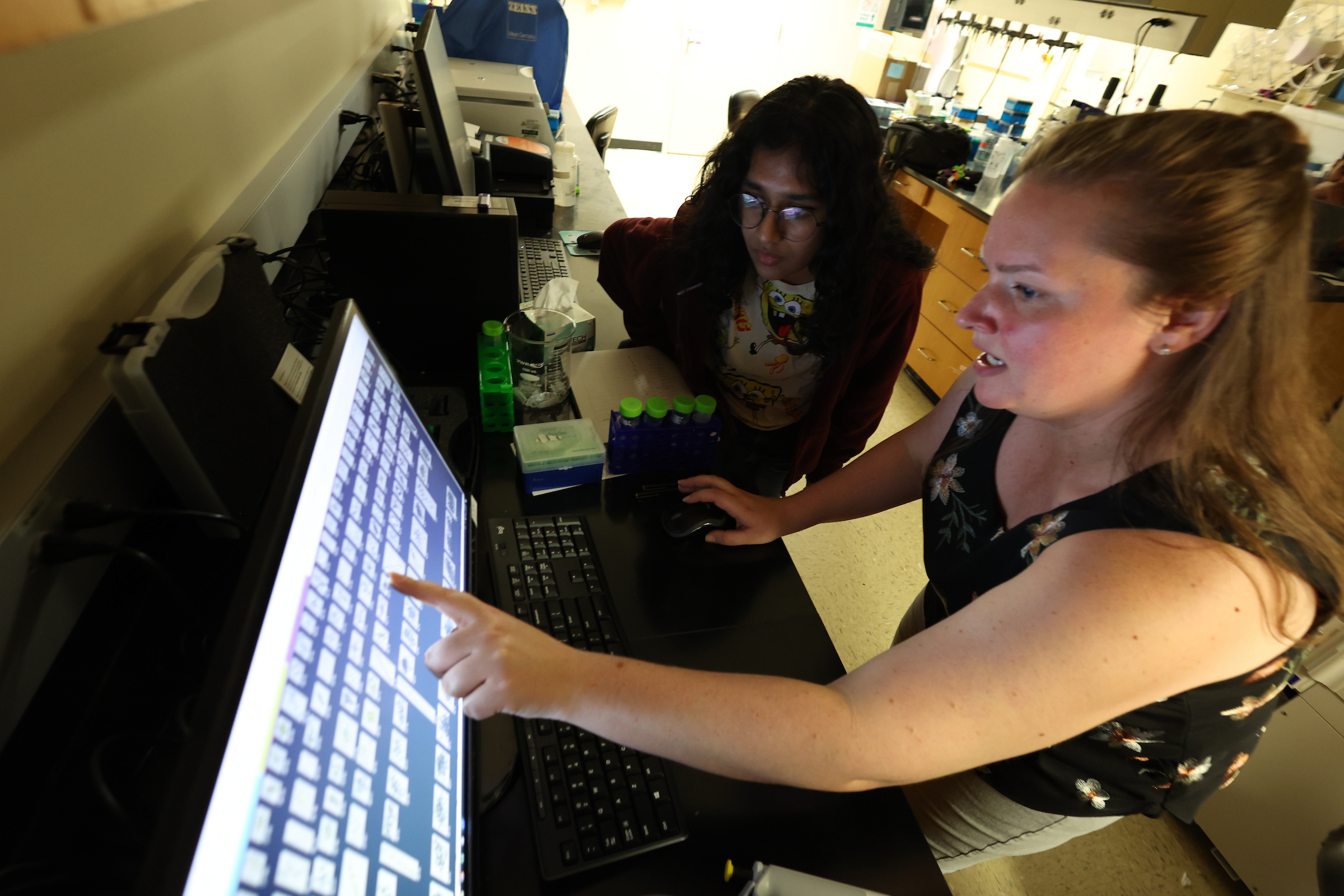 Katelyn McKindles studies water data on computer with student