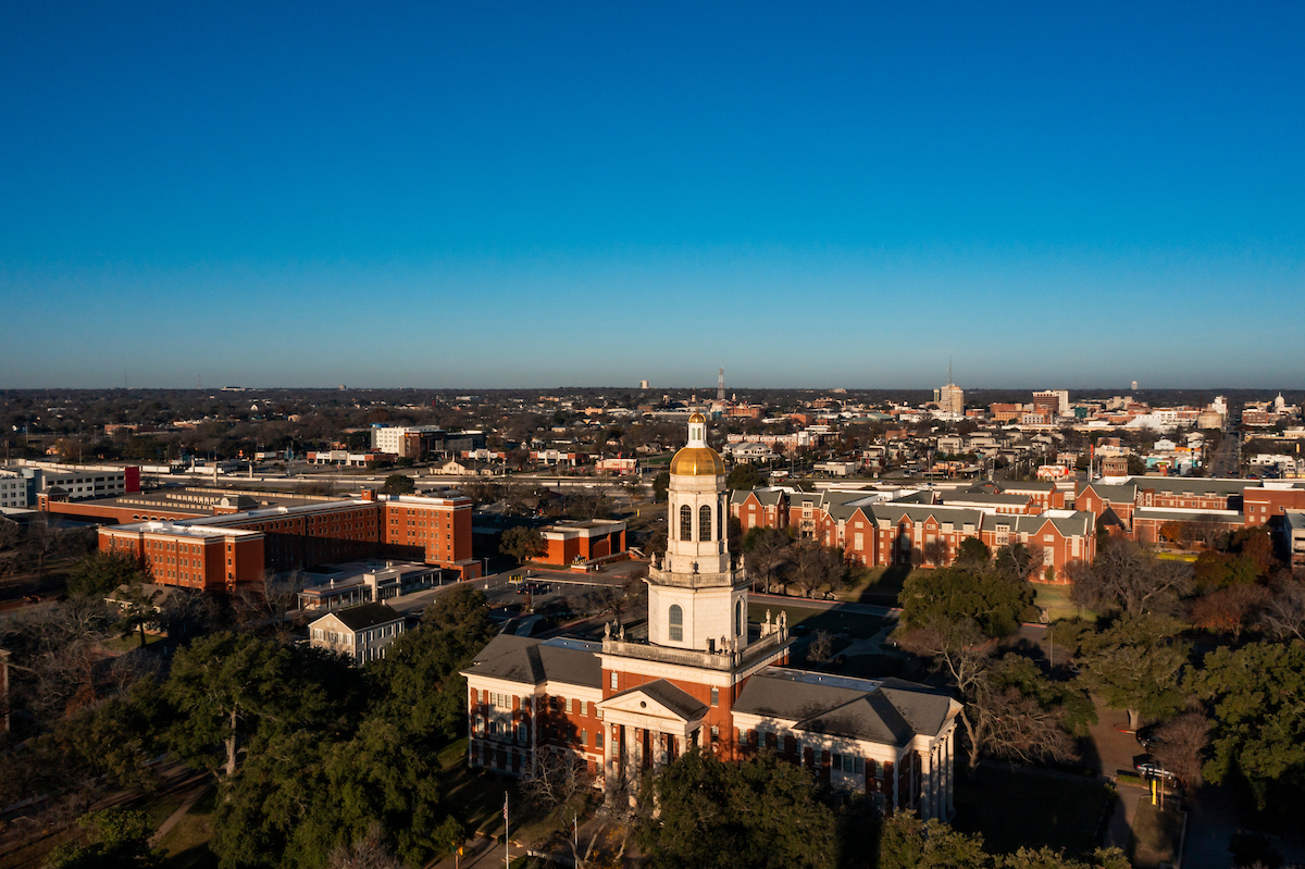 Aerial shot of Baylor University's Pat Neff Hall with city of Waco in the background.