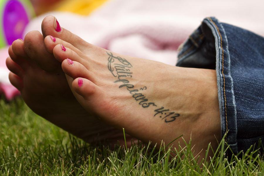 Woman's foot with Phillippians 4:13 tattoo.
