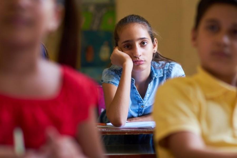 A young woman appears disengaged in classroom