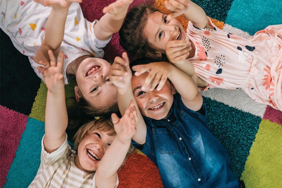 Image of children in a circle, happy and smiling